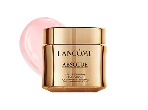 Crema viso Lancôme Absolue in un vaso dorato, con un tocco di crema rosa sul lato.
